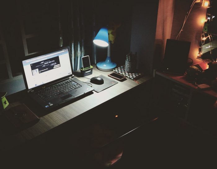 black laptop beside black computer mouse inside room